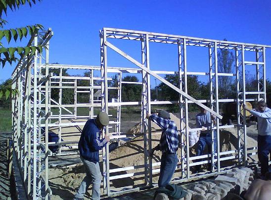 03 sandbag house2.jpg - Workers erect the wooden frames for the construction for Vastu houses in the Ukraine. Once ready, the frames will be filled with filled with sand held in small, breathable plastic bags.